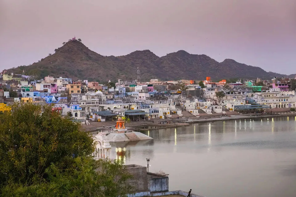 Scenic view of Pushkar Lake with ghats and surrounding hills in Rajasthan